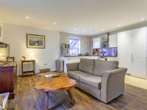 a living room with a couch and a table at The Bungalow in Dingwall