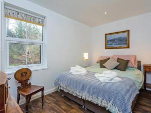 a bedroom with a bed with towels on it at The Bungalow in Dingwall +6 photos