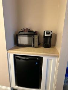 a microwave and a toaster oven on a counter at The Monterey Hotel in Monterey