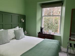 a bedroom with a large bed and a window at Birchwood Pitlochry in Pitlochry