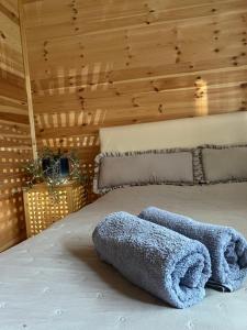 a bed with two towels on it in a room at Plava Zora in Kolašin