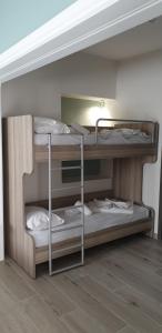 two bunk beds in a room with a floor at Chriselia Studios in Nea Roda
