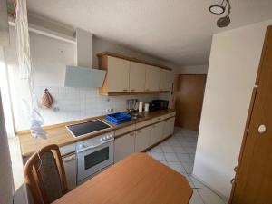 a kitchen with a table and a stove top oven at Ferienwohnung Matthias Lang in Rugendorf