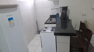 a small kitchen with a stove and a microwave at my sweet place 33 in São Luís