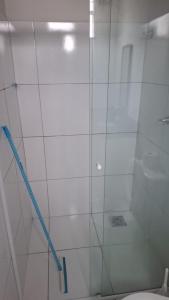 a shower with a glass door next to a toilet at my sweet place 33 in São Luís