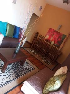 a living room with a couch and a painting on the wall at Kalubowila Rooms in Dehiwala
