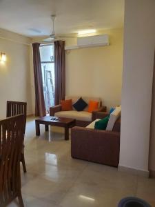 a living room with two couches and a table at Kalubowila Rooms in Dehiwala