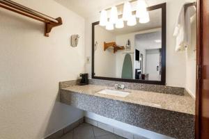 a bathroom with a sink and a large mirror at The Cherrywood Inn in Georgetown