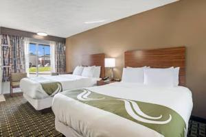 a hotel room with two beds and a window at The Cherrywood Inn in Georgetown