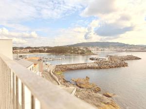 a view of a body of water from a balcony at Blue Ocean Deluxe in Sanxenxo