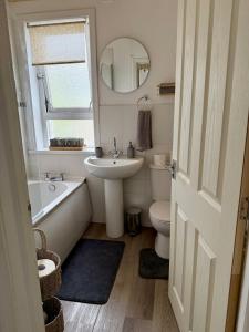 a bathroom with a sink and a tub and a toilet at 15 By The Shore in Caol +20 photos
