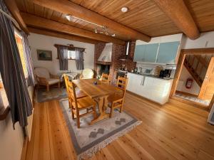 a kitchen and dining room with a wooden table and chairs at Bonäs bygdegård in Mora