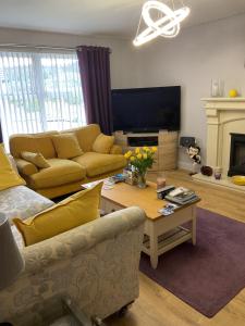 a living room with a couch and a table at Hillside Luxury Bed & Breakfast in Ballycastle