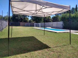 a large white canopy over a swimming pool at Quinta El Encuentro Junín in Junín