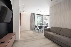 a living room with a couch and a table at Palatium Riccione Suite in Riccione