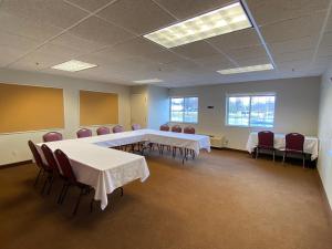 a conference room with tables and chairs in it at Edmore Inn in Edmore