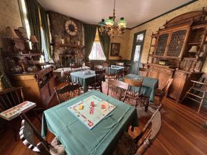 a dining room with tables and chairs and a clock at American River Inn in Georgetown +8 photos