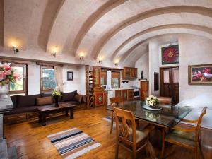 a large living room with a table and chairs at Minia Cave Hotel in Ortahisar