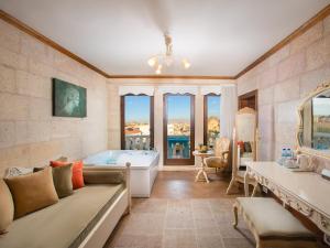 a large bathroom with a tub and a large window at Minia Cave Hotel in Ortahisar