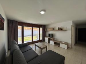 a living room with a couch and a table at Sun Club Bungalows in Playa del Ingles