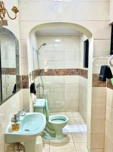 a bathroom with a toilet and a sink at Mi Refugio 1 in Río San Juan +9 photos