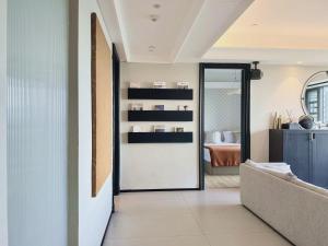 a hallway with a door leading to a bedroom at ChangSha YunXi Riverview Hotel in Changsha