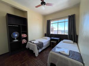 a hotel room with two beds and a window at Rosa's Hotel in Toledo