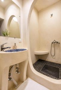 a bathroom with a round sink and a mirror at Riad Zaitouna Chaouen in Chefchaouen +121 photos