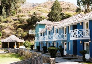 a row of blue houses on a hill at Aranwa Pueblito Encantado del Colca in Coporaque