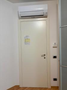 a white door with a air conditioner on top at G&G Suites in Bugia