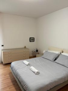 a bedroom with a bed with a remote control on it at G&G Suites in Bugia