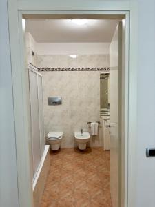 a bathroom with a toilet and a sink at G&G Suites in Bugia +54 photos