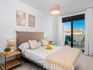 a bedroom with a bed with a yellow hat on it at Villa Del Pescador in Santiago de la Ribera +62 photos