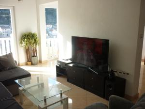 a living room with a large flat screen tv at Apartments Nikola in Pučišća