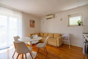 a living room with a couch and a table and chairs at Bella Vita in Korčula
