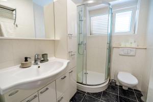 a bathroom with a sink and a shower and a toilet at Bella Vita in Korčula +20 photos