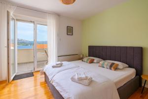 a bedroom with a large bed and a large window at Bella Vita in Korčula