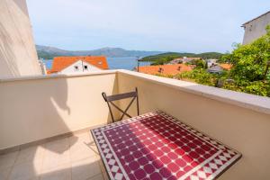 a chair on a balcony with a view of the water at Bella Vita in Korčula