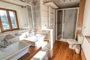 a bathroom with two sinks and a toilet at La Ferme Des Astres in Les Angles +37 photos