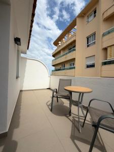 a patio with a table and chairs on a building at Hotel Avenida 31 in Marbella