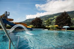a large swimming pool with a water slide at Appartement Wurm- nahe Hochzillertal für Familien in Kaltenbach