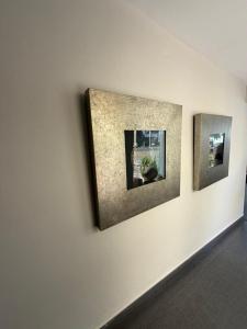 three pictures on a wall in a room at Hotel Avenida 31 in Marbella