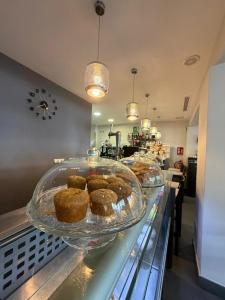 a display case with muffins on a counter in a store at Hotel Avenida 31 in Marbella