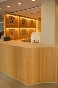 an office lobby with a wooden reception desk at Kyrat Amarac - Adults Only in Cala Millor +34 photos