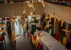 a dining room with tables and chairs with lights at Aranwa Pueblito Encantado del Colca in Coporaque +77 photos