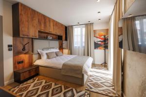 a bedroom with a bed with a wooden wall at Къща за гости Domus Harmonia - Jacuzzi & BBQ near Bansko in Banya