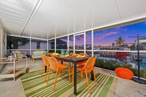 a dining room with a table and chairs on a balcony at Casa Azul - Waterfront Villa with Pool & Dock in Marco Island +34 photos