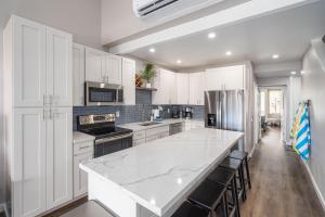 a kitchen with white cabinets and a large white counter top at 257 Hale Kamaole in Wailea