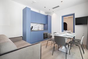 a dining room with blue walls and a table and chairs at Palatium Riccione Suite in Riccione