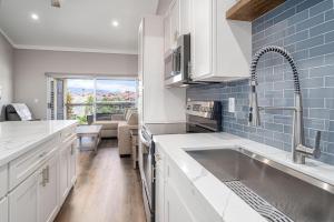 a kitchen with white cabinets and a sink at 257 Hale Kamaole in Wailea